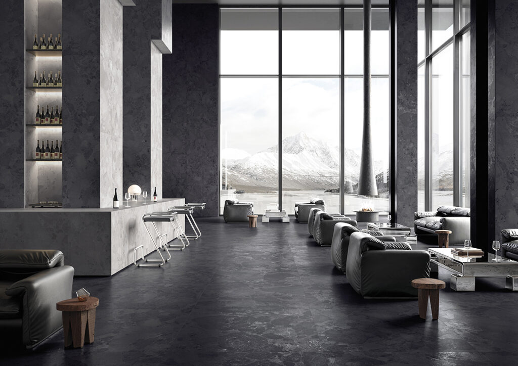 Les couleurs tendance 2026 à surveiller. La collection Moon, imitation pierre, couleur galet, au plancher d'un bar.